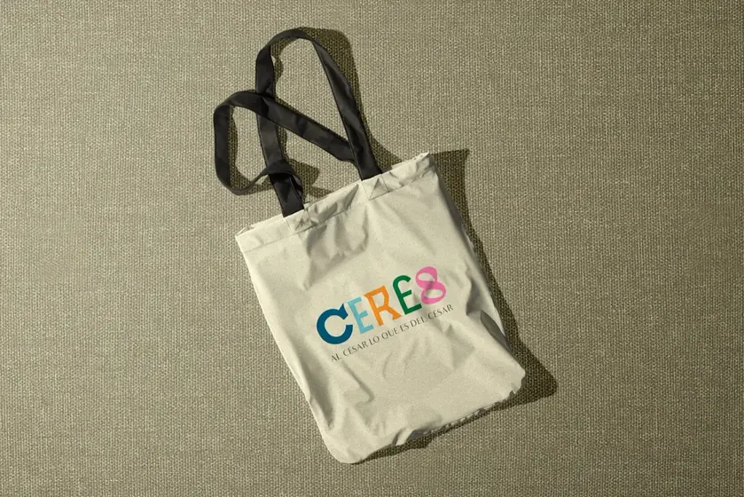 Cream fabric tote bag with the Ceres logo on an olive green surface